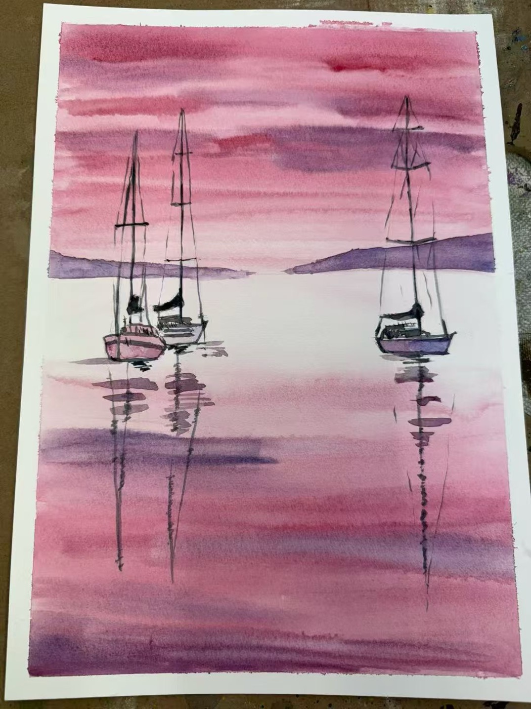 Watercolour of sailing boats on pink water
